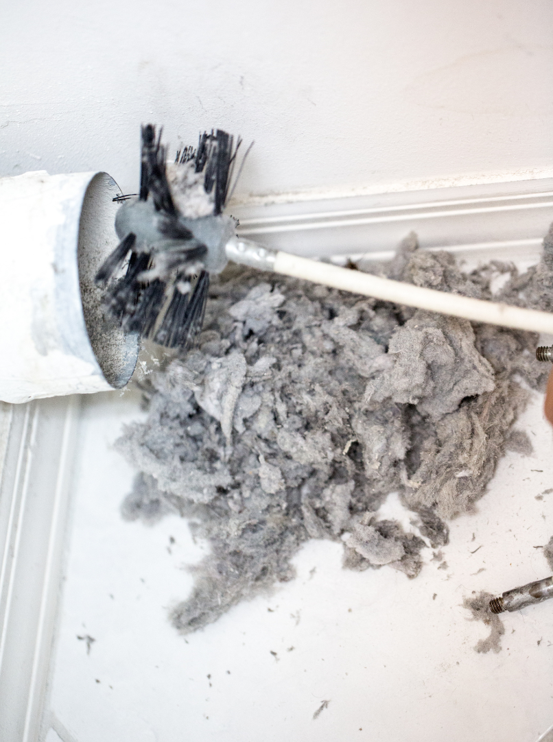 professional dryer vent cleaning technician at work